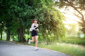 Portrait of beautiful asian Young woman in white robe wearing sportswear jogging working out...