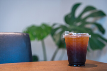 Close-up of Americano ice coffee or black coffee in cup mug on  wood desk office desk in coffee...