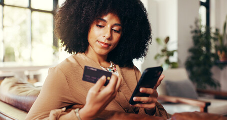 Credit card, phone and woman on couch with online shopping with sale, discount or promotion in...