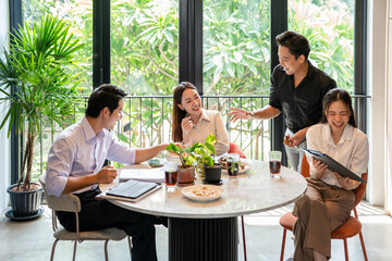 Group of Young Business People on Break in Office. Successful Business Team Talking on Coffee Break. Young Smiling Colleagues on Break Drinking Coffee Chatting in Modern Office. Corporate Lifestyle.