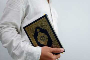 Man Holding a Religious Book Exploring Faith, Spirituality, and the Quranic Concept 
