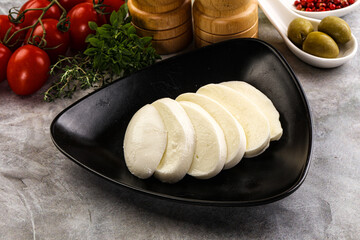 Organic mozzarella cheese slices in the plate