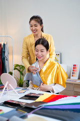 Stylist analyzes color for young woman. Fashion stylist or image consultants consider individual...
