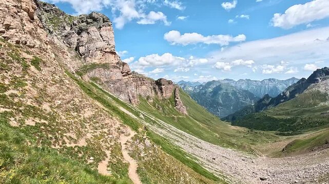 Alpine path leads down from Passo di Valtendra with a wide view toward Alpe Devero and Monte Cistella range.