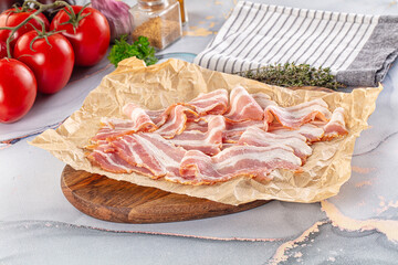 Sliced pork bacon over board