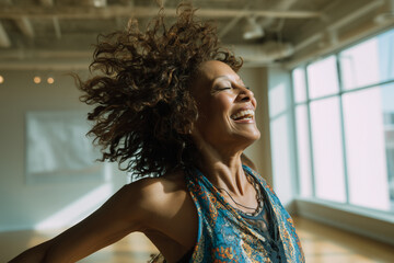 Joyful Mature Woman Dancing Freely in Sunlit Studio &ndash; Active Lifestyle and Happiness Concept