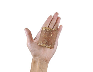 Natural brown sugar block in hand, isolated on white for culinary or health-themed design