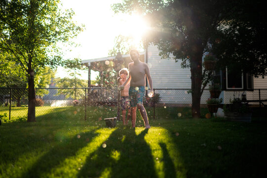 Water fight joy between kids in evening light outdoors