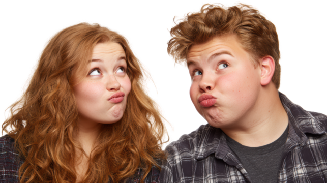 Two teenagers playfully making funny faces, isolated on a white background.