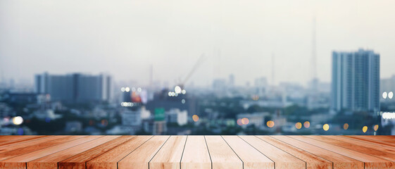 Wood tabletop cityscape metropolis evening skyscrapers buildings illuminate urban lights panorama modernity residential night lights downtown skyscraper reflection contemporary atmosphere.