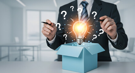 businessman holding a light bulb