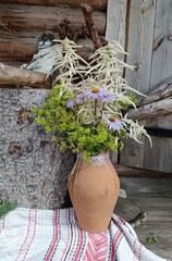 beautiful bouquet of wildflowers in a clay jug, flowers, floral decor