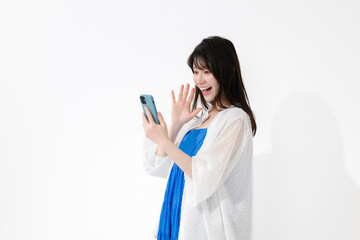 笑顔でスマートフォンを持つ女性