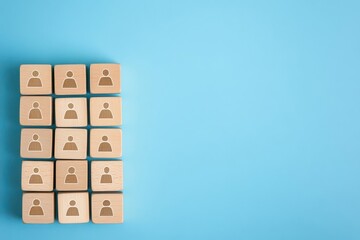 Fototapeta premium Building a strong team, Wooden blocks with people icon on blue background, Human resources and management concept