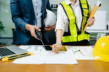 Creative architect projecting on the big drawings with architectural project at construction site...