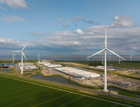 Wind turbines near datacenter construction in Eemshaven - Powered by Adobe