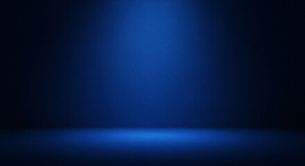 A spotlight illuminates a textured dark blue studio background creating a dramatic and moody atmosphere with a clear separation between floor and wall