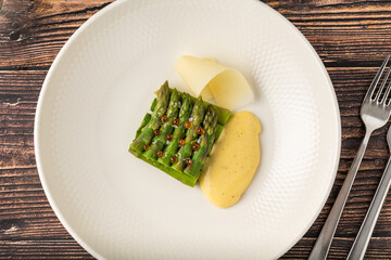 Steamed asparagus with hollandaise sauce and decorative potatoes