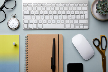 Organized office desk with keyboard, mouse, and stationery