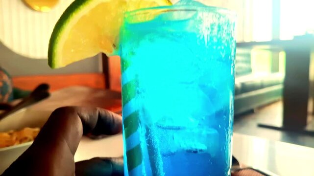 Refreshing Blue Lagoon drink with vibrant blue color, lemony citrus flavor, vodka, and lemonade&mdash;perfect for summer parties and relaxation