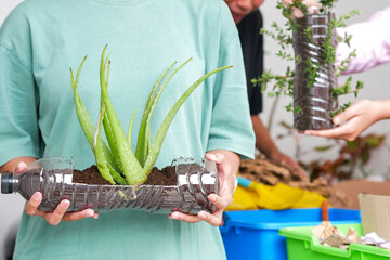 Selective Focus of Hands Holding Recycled Plastic Bottle Serving As Planter