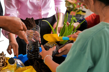 Hands Carefully Adding Soil And Aloe Plant To Handmade Recycled Planter Promoting DIY Eco Crafts