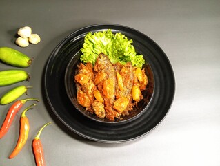 Indonesian Sour-Spicy Fish Cooked with Starfruit on Black Plate