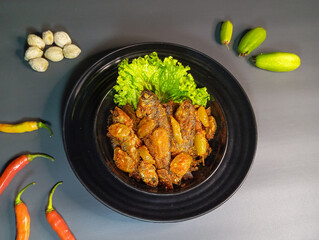 Spicy Tamarind Fish with Starfruit and Lettuce on Gray Background