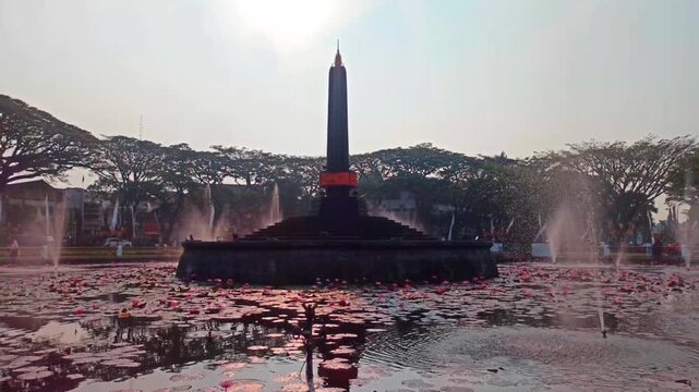 Footage Malang City Hall and Malang Monument are surrounded by flower gardens and fountains.
