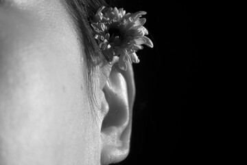 Black and White Close-Up of Ear with Flower