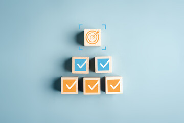 Checklist target process planning strategy checkmarks and goal on wooden blocks project steps,...