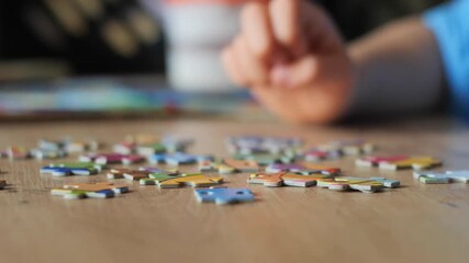 Child's Hand Picking Puzzle Piece