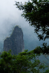 Fog rolling through limestone mountain forest
