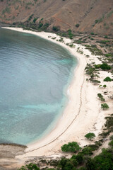 Beautiful view of Cristo Rei Backside Beach or known as Dolok Oan Beach in Dili, Timor Leste. Aerial view of tropical beach.