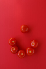 Fresh red tomatoes on red background