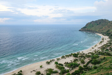 Fototapeta premium Beautiful view of Cristo Rei Backside Beach or known as Dolok Oan Beach in Dili, Timor Leste. Aerial view of tropical beach.