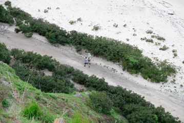 People walking at Cristo Rei Backside Beach or known as Dolok Oan Beach in Dili, Timor Leste