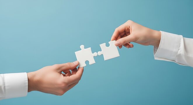 Two hands connecting puzzle pieces, symbolizing teamwork and solutions