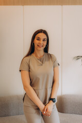 Young beautician smiling and posing in beauty salon