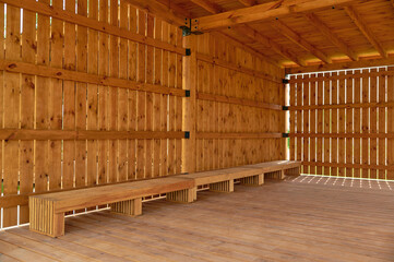 wooden pavilion interior showcasing natural wood tones and minimalistic design. features rustic...