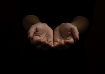 Praying hand pose with both empty hands gently outstretched, expressing a quiet plea or offering. The image reflects concepts of donation, hope, and spiritual openness in a minimalist, dark setting.