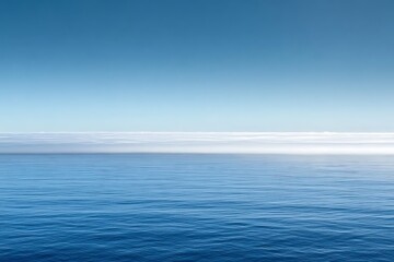Obraz premium Vast Ocean Scene with Blue Sky and Distant Clouds Enhancing Tranquility and Peace