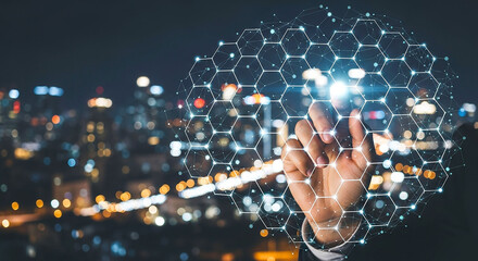 Hand interacting with digital network over city lights at night in a dark background scene view