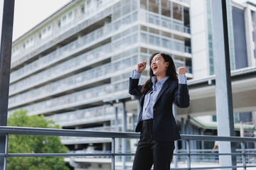 Young businesswoman celebrating success in urban setting