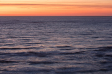 View across the ocean and sky to the sunset