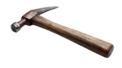 A slightly rusted metal hammer with a wooden handle isolated against a black background image view