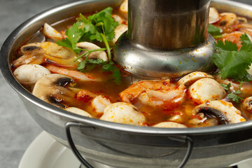 A closeup view of a bowl of tom yum goong.