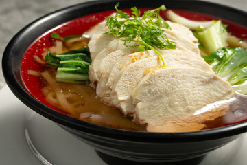 A view of a bowl of Thai chicken noodle soup.