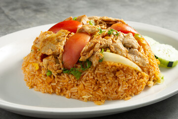 A view of a plate of pork fried rice.