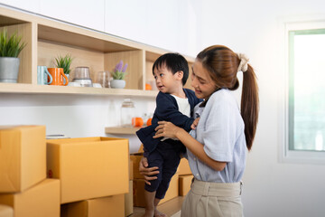 Sell Online: Caring mother managing e-commerce while holding child